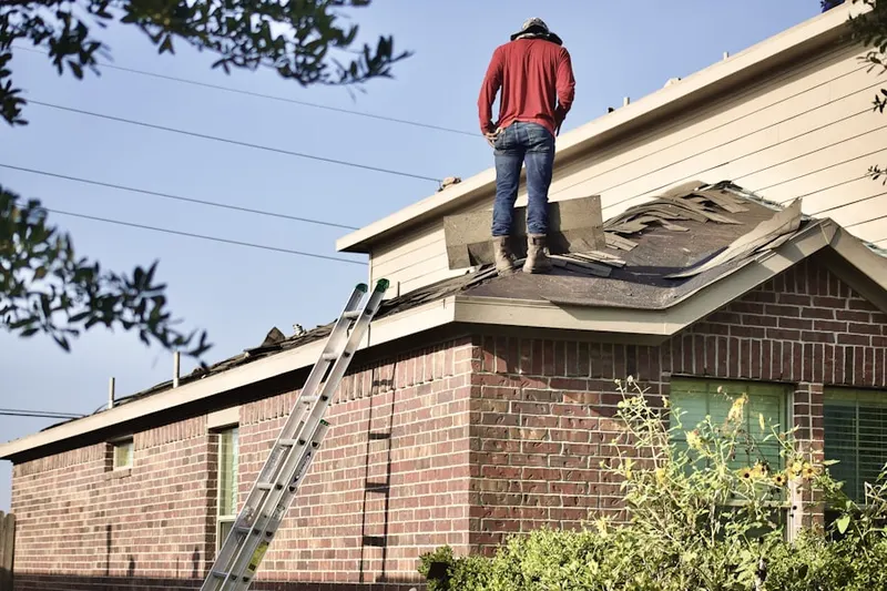 Professional roofer working on a residential roof in Harris Ranch